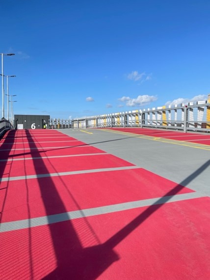 photograph of red parking bays on the top of a car park